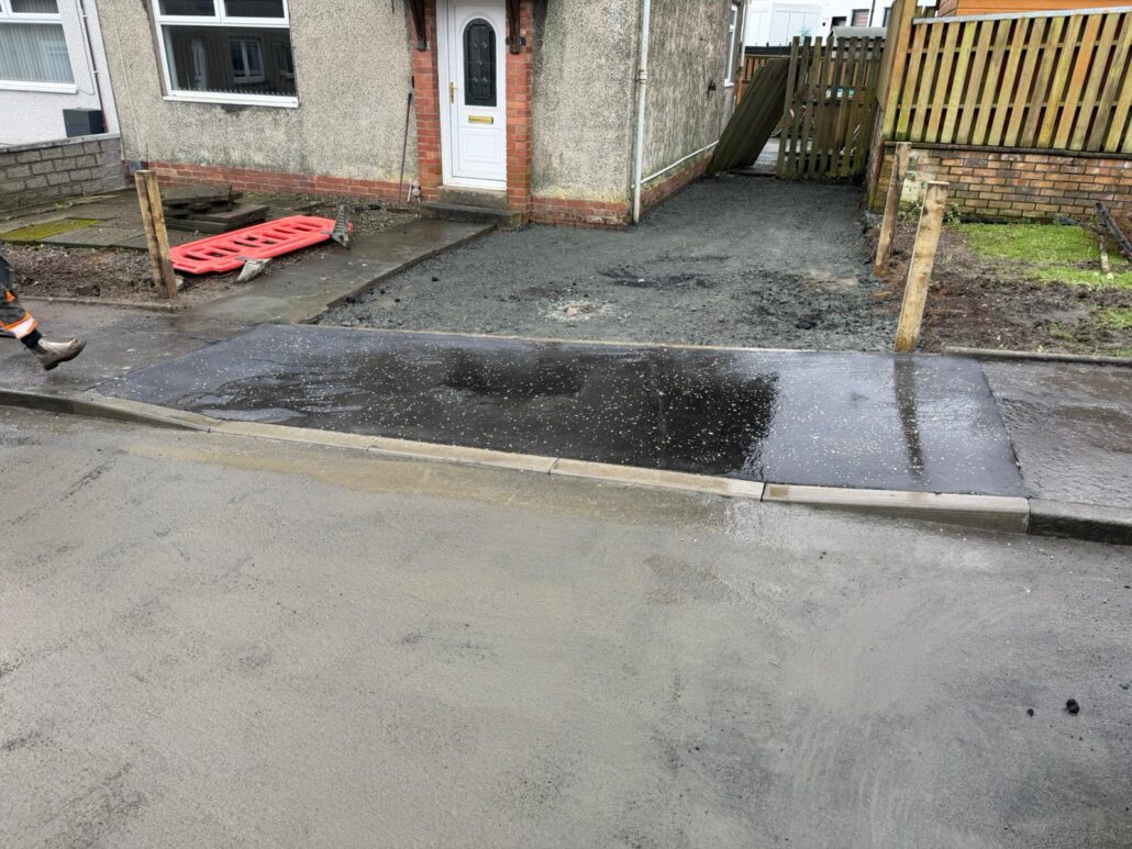 Drop Kerb Contractors Working On Residential Driveway